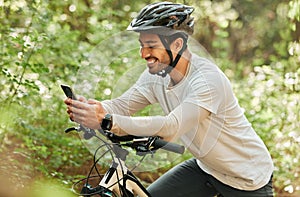 Man, forest and phone on bike, texting and smile for web chat notification on adventure in nature. Guy, cycling and