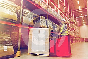 Man on forklift loading cargo at warehouse