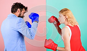 Man formal suit and athletic woman boxing fight. Couple in love competing in boxing. Female and male boxers fighting in