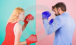 Man formal suit and athletic woman boxing fight. Couple in love competing in boxing. Female and male boxers fighting in