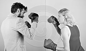 Man formal suit and athletic woman boxing fight. Couple in love competing in boxing. Female and male boxers fighting in