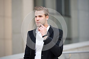 Man formal suit businessman well groomed urban background. Professional attire wear in professional environments