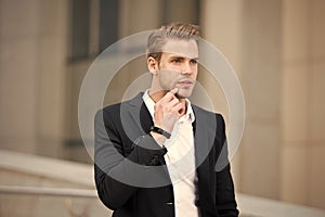 Man formal suit businessman well groomed urban background. Professional attire wear in professional environments