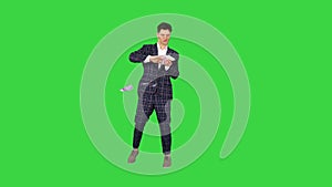 Man in formal suit walking in and throwing money in the air on a Green Screen, Chroma Key.