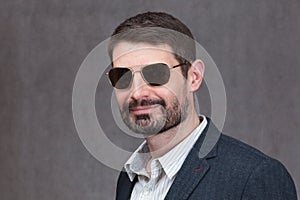 Man in Forties with a full beard and sunglasses