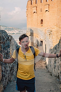 Man at fortress ruins of the historical Red Tower