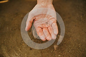 The man found gold. Contemporary lucky prospector found lot of gold in creek when panning sand