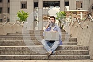man freelancer has video call on laptop, advertisement. man freelancer has video call outside.