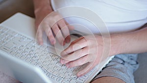 Man freelancer working on laptop at home-office. Close up of hands typing on keyboard. Businessman writing business