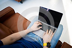 Man freelancer working on laptop sitting in chair