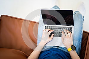 Man freelancer working on laptop sitting in chair