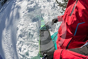 Man freerider installs glue camus on skis, in snow wild mountains
