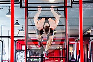 Man at freestyle Calisthenics training in gym photo