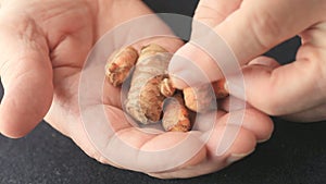 Man with fresh turmeric