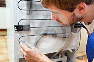 Man during fridge repair