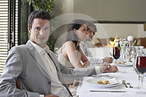 Man With Friends Having Formal Dinner Party