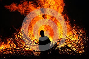 Man in front of a bonfire