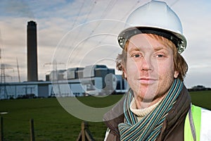 Man in front of an electricity pylon