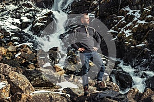 Man in front of Latefossen waterfall in winter, Norway