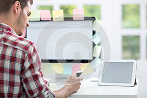 Man front of monitor with notes on it