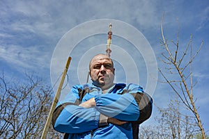A man in front of a television tower. Master`s services for connecting tele-radio communications
