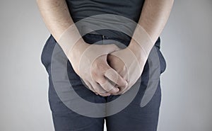 Man front view. Pain in the groin and bladder. The concept of pain in men as a result of prostatitis, inflammation of the bladder photo