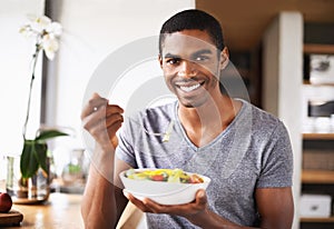 Man, fruit salad and plate in portrait for eating, detox or happy in home kitchen for breakfast. African person, smile