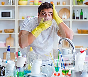 Man frustrated at having to wash dishes