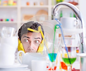 Man frustrated at having to wash dishes