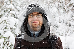 Man in fur winter hat with ear flaps smiling portrait