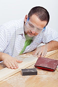 Man furbishing wooden planck