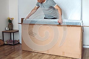 The furniture assembler assembles the bed frame, do it yourself and assemble new furniture