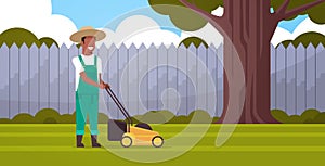 Man gardener cutting green grass with lawn mover african american farmer moving garden backyard gardening concept flat