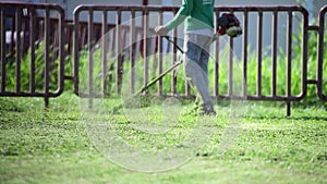 Man gardener working lawn mower,Cutting grass in the park, Slow motion