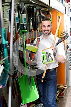 Man with gardening tools in the shop