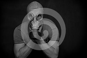 The man in a gas mask on a black background.