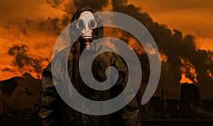 Man in gas mask and cloak of chemical protection with heavy industry plants