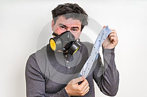 Man with gas mask is holding stinky sock