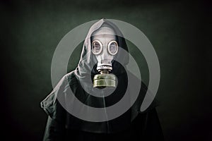 Man in a gas mask and hooded cloak photo