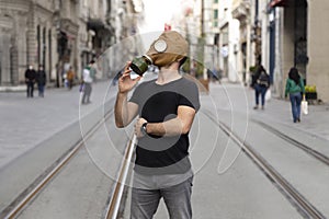 Man in gas mask poses to the camera on the streets of Istanbul