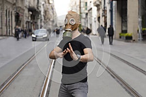 Man in gas mask poses to the camera on the streets of Istanbul