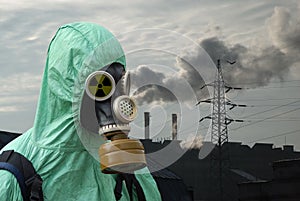 Man in gas mask on smoky background