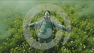 man in gas mask soar over green nature field, ecology concept, world pollution environment disaster concept