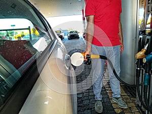 Man with gas pump in his hand