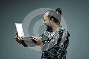 Man gawping at his laptop with an aghast expression