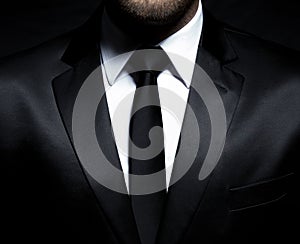 Man gentleman in black suit and tie