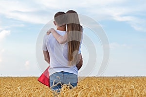 Man gently holding his beloved in wheat field. Romantic time outsides