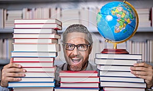 Man geographer with books in classroom. Knowledge and education concept. school teacher with book in classroom. teacher
