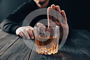 Man with a gesture refuses alcohol