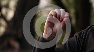 A man gestures with his hand while talking, trying to explain with a gesture